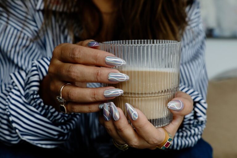 woman holding latte bold nails