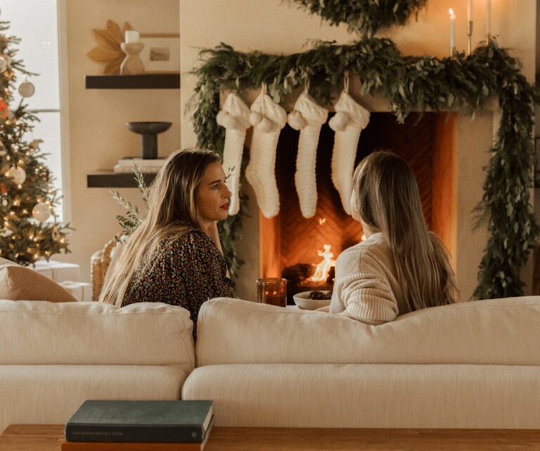 women talking by fireplace e1731350628256