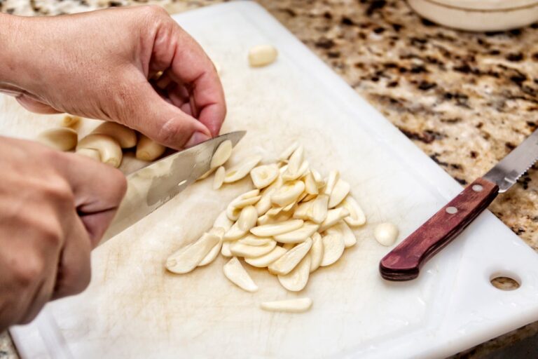 Slicing garlic on cutting board