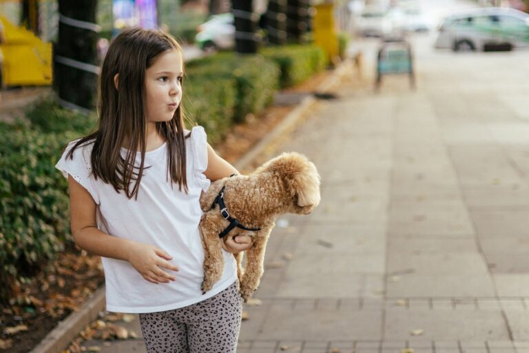 young girl carrying dog